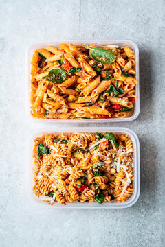 Pasta salads with penne and rotini, spinach, tomato