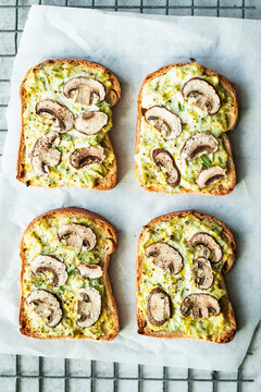 Tarte flamb&eacute;e toast topped with cremini mushrooms and cheese