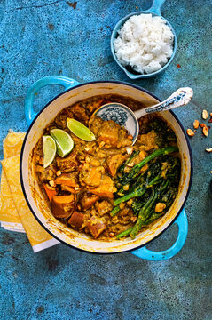 Satay Sweet potato Curry with broccolini and lime wedges