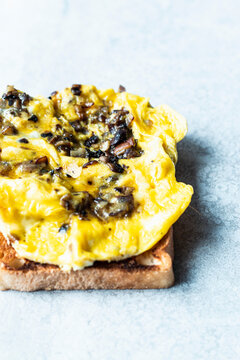 Scrambled eggs with mushrooms on toasted bread