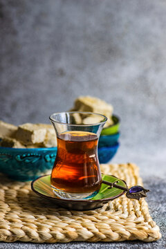 Glass of Turkish tea served with dessert halva