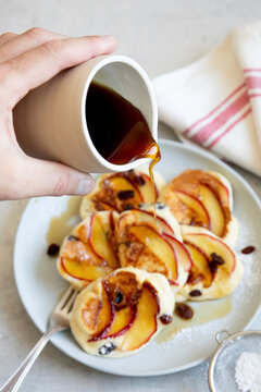Apple pancakes with sultanas and maple syrup