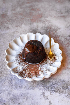Chocolate Lava Cake with molten chocolate on white plate