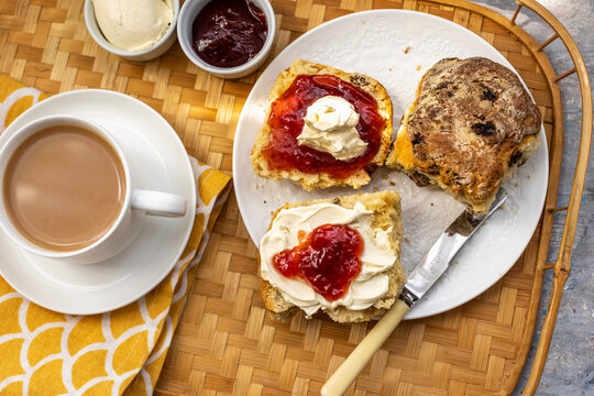 Scones with clotted cream and strawberry jam served with Tea