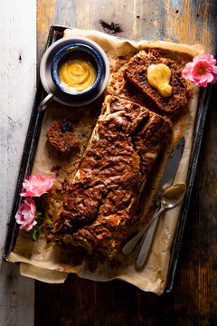 Chocolate zucchini bread loaf with maple butter on rustic board