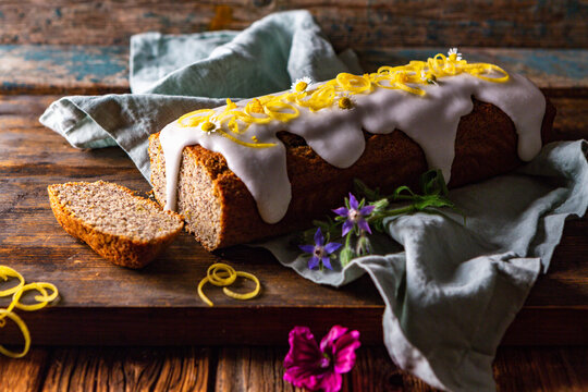 Poppy seed and lemon loaf cake with camomile flowers and icing