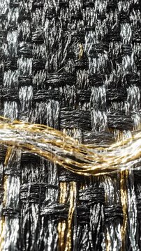 Macro Close Up of Textured Woven Fabric With Metallic Gold and Silver Threads Interlaced in Pattern