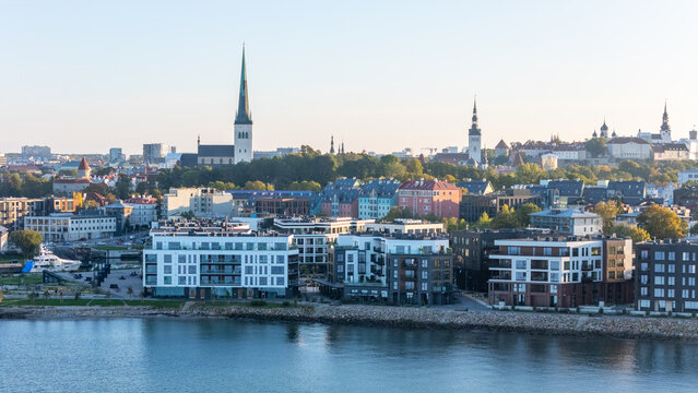 Panoramic aerial view of Tallinn with St. Olaf's Church, Old Town towers and modern Kalaranna waterfront, Estonia