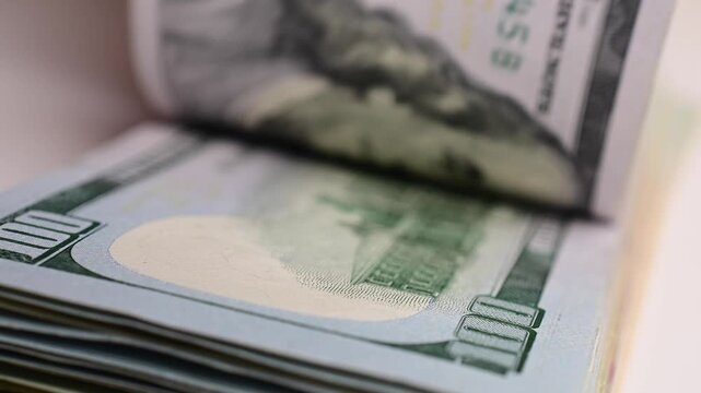 Stock of hundred dollars bills bokeh macro close up, texture, in and out of focus, abstract money finances, studio selective focus real time video	