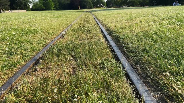 Railway tracks over park grass