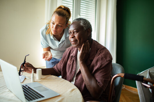 Caregiver helps senior man describe neck pain during video call