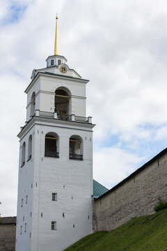 Trinity Cathedral, Pskov. It has, since 1589, been the mother church of the Pskov. Vertical photography shows a striking view of a historic white bell tower set against a backdrop of cloudy blue sky
