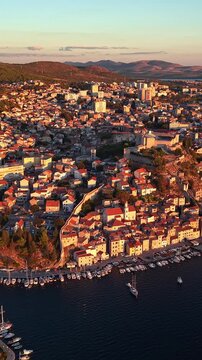 Sibenik, Croatia, aerial view of the historic old town, fortress, and marina at sunset