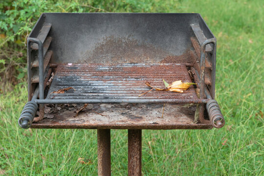 close up of a rusty iron charcoal grill , free for road trippers and travelers to use at a highway rest stop in America