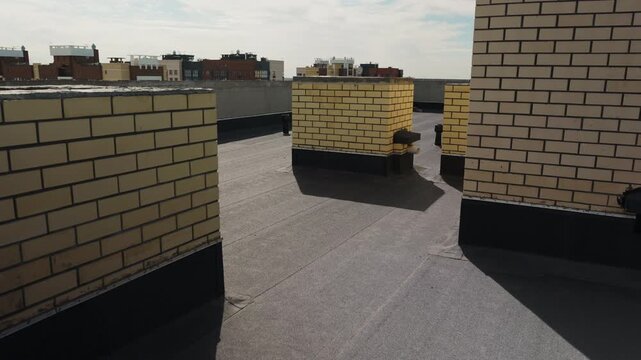 Flat roof with brick ventilation shafts and waterproof membrane