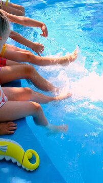 Children are swimming and playing in the pool. Selective focus.