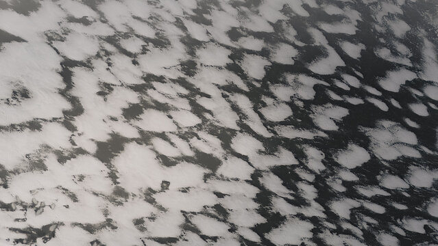 Aerial view of frozen sea surface with intricate patterns of ice and snow in Sandhaken, Vastra Gotaland County, Sweden.