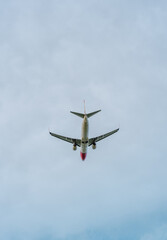 Commercial passenger aircraft photographed from below as it flies across a pale blue sky. The aircraft is positioned centrally with extensive negative space, making the image suitable for travel adver © Наташа Фомина