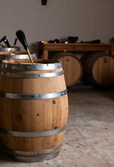 Naklejka premium Winemaking and craft production, wooden wine barrel with bung tool in traditional cellar for fermentation and aging process in winery industry