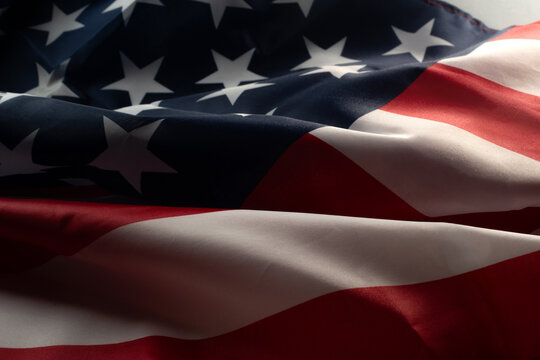 Close up of wavy draped American flag showing stars and stripes for patriotic national background