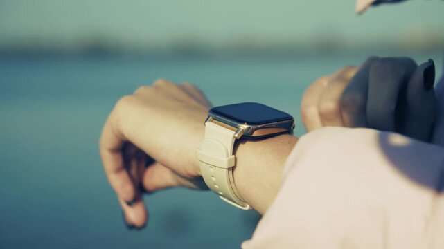 Touching Smartwatch Screen While Standing Near Water Outdoor