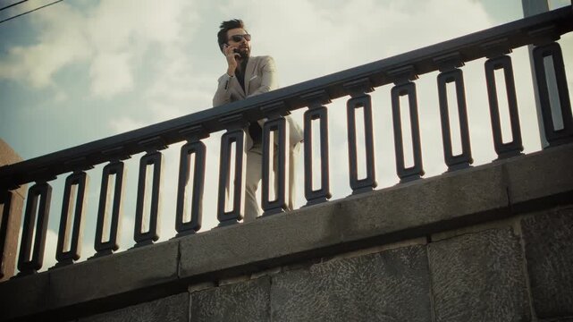 Businessman Looking Away While Standing By Metal Railing 