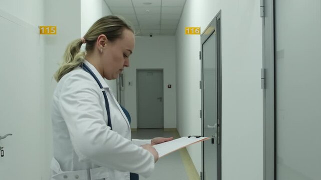 Woman doctor studies document containing laboratory test results. Highly qualified physician reviews important medical report. Slow motion
