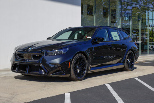 BMW M5 Touring wagon at a dealership. BMW offers the M5 with a 717HP 4.4L TwinPower Turbo 32-valve V8 engine. MY:2027