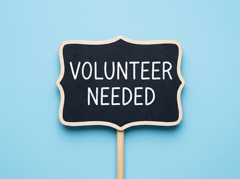 Volunteer needed sign on a chalkboard