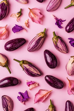 Flat lay of eggplants arranged in a pattern on a beige pink background, showcasing minimalism and high quality professional photography.
