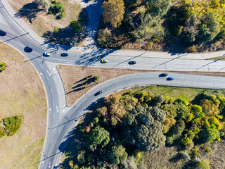 Fototapeta premium Traffic observed from above at a roundabout in a suburban area during daytime