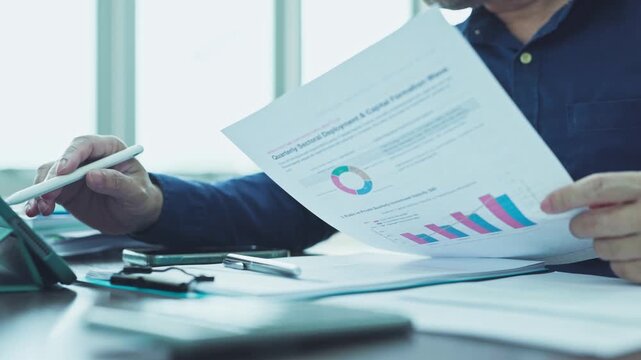 Auditor conducts thorough audit procedures, examining financial report documentation as external audit teams complete report verification.