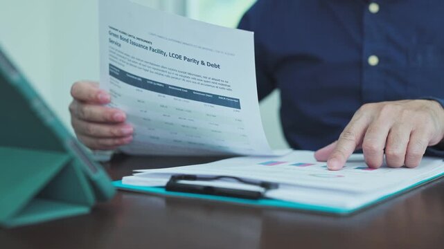 Financial analysis specialist reviews investment report, conducting analysis bond yields as corporate analysis evaluates esg investment metrics.