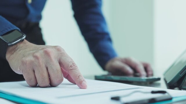 Auditor conducts audit inspection reviewing financial document records, ensuring audit compliance across corporate accounts.