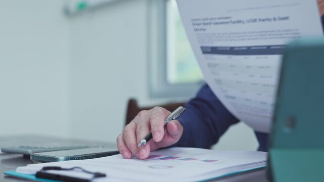 Analyst conducts investment research on sustainable bond assets, evaluating corporate investment metrics as strategic research guides investment capital.