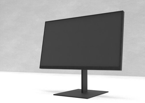 Monitor negro con pantalla apagada en vista angular sobre una superficie clara y fondo gris. Perfecto para presentar proyectos digitales.