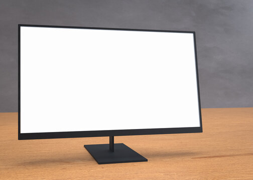 Pantalla de monitor en blanco brillante sobre un escritorio de madera con fondo gris texturizado. Vista en &aacute;ngulo, lista para tu dise&ntilde;o.