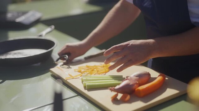 Chef prepares fresh ingredients on a wooden cutting board in a kitchen