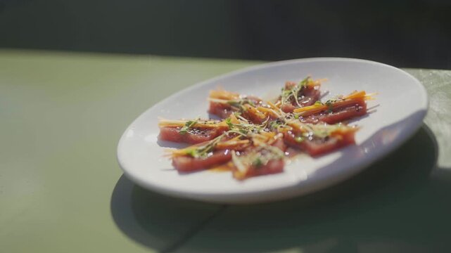 Gourmet tomato dish plating with fresh ingredients on a white plate