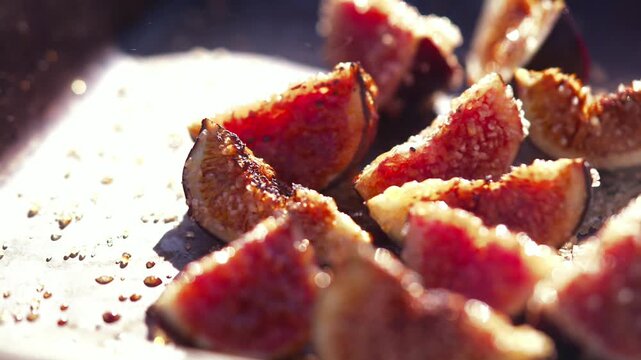 Grilled fig halves sit on a metal grill, ready for a gourmet meal