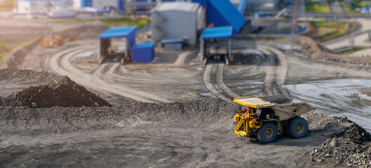 Heavy dump truck at mining gold ore quarry site with dirt roads and industrial equipment © Parilov