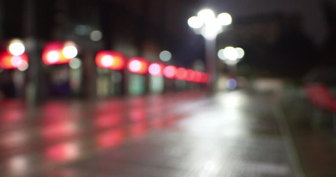 Bokeh - A street in Milan lit by red streetlights