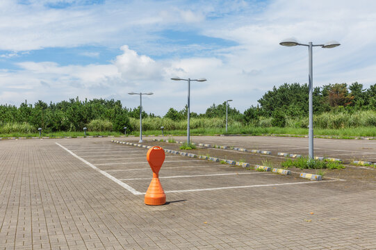 Empty Outdoor Parking Lot with Traffic Cone and Street Lights