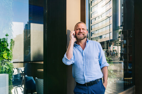 Man talking on cell phone in city street