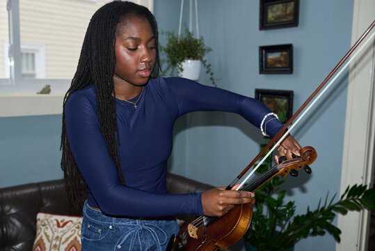 Girl tuning violin