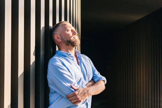 Man enjoying sunlight on face feeling relaxation