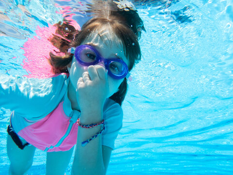 Young girl swimming underwater