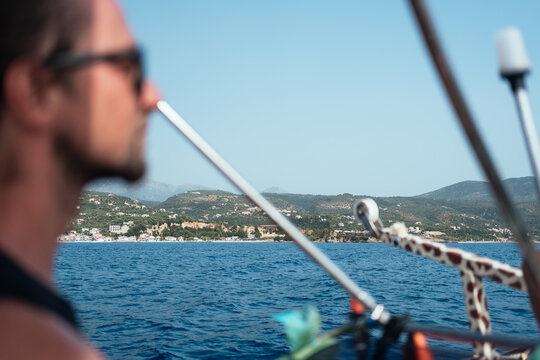 man looking across the sea during a summer boat trip