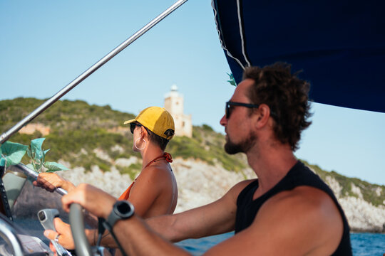 friends cruising along the greek coast by boat