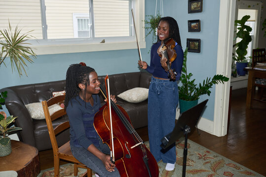 Two smiling girls practicing music